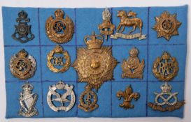 Fourteen cap badges, including 21st County of London, 7th Bn Manchester Regt, pre 1920 Queens, and