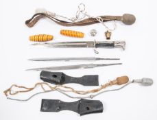 An assortment of Third Reich dagger and bayonet parts: 3 bayonet blades, 2 frogs, 3 sword knots, 2