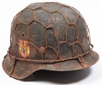 A Third Reich M1943 raw edge steel helmet, in combat condition with traces of "Blue Division"