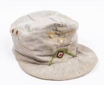 A Third Reich Afrika Corps field cap, with Bevo type woven insignia, marked inside "Carl Halfa