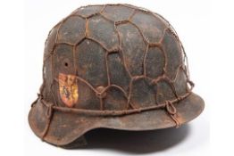 A Third Reich M1943 raw edge steel helmet, in combat condition with traces of "Blue Division"