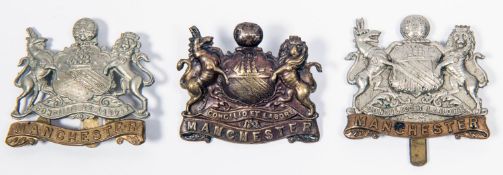 3 pre 1923 Manchester Regiment cap badges: bi-metal, non-voided bi-metal, and non-voided bronze