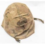A US Army WWII steel helmet, swivel bales, rear rim seam, complete with liner and camouflage