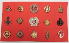 Fifteen mainly military cap badges, including Yorkshire Regt HPC, Ryl Guernsey Militia, Queen