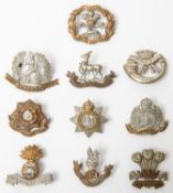 10 early lugged examples of Infantry cap badges: Royal Warwickshire, Norfolk, Devonshire, Suffolk,
