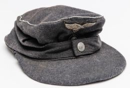 A Third Reich Luftwaffe officer's field cap, badges and braid trim of silver alloy. GC £250-300