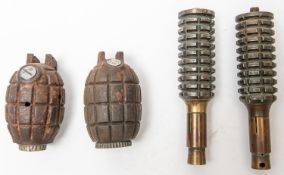 A WWI Mills Bomb, lever missing, another similar drill type, lever missing, the main body sections