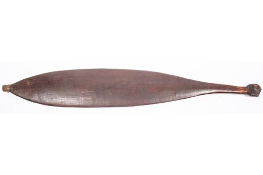 An Australian aborigine wooden spear thrower "wommera", 25" overall, of slightly concave spatulate