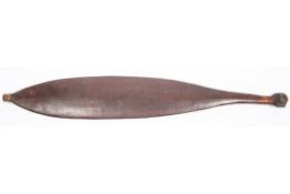 An Australian aborigine wooden spear thrower "wommera", 25" overall, of slightly concave spatulate