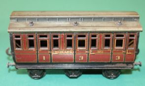 A rare O gauge Carette Clemenson 6 wheeled clearstory passenger coach. A composite 1st/3rd class