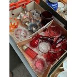 A box of cranberry glass and a box of mixed glassware including carnival