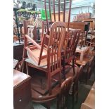A mid 20th century teak dining table and six chairs together with a mid 20th century teak dining