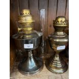 A vintage Aladdin No. 23 paraffin lamp together with a another, both with funnels, no shades.