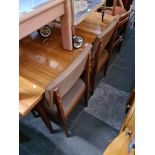 A mid 20th century extending dining table and four chairs.