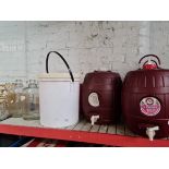 Home brew equipment comprising three demi johns, three barrels and a bucket.