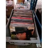 A box of various vinyl LP records