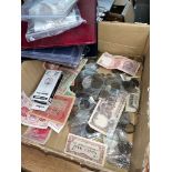 A box of GB and world coins and banknotes