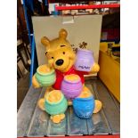 A Disney Winnie the Pooh ceramic piggy bank in box.