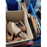 A box of shoe trees and two vintage tennis rackets.