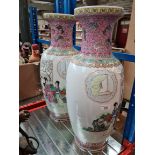 A pair Oriental vases decorated with figures and characters.