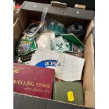 A box of badges and collectables including Cannon camera lense, etc.