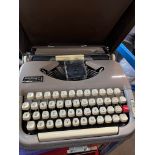 A vintage Scheidegger Princess-Matic typewriter in original case.
