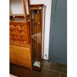 An early 20th century oak and glass elongated shop display cabinet.