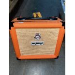 An Orange Crush 12 guitar amplifier.