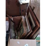 A box containing various pictures and a vintage mirror.