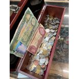 A box of mostly world coins and banknotes.
