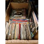 A box of 45s and some soundtrack LPs.