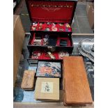 A jewellery box containing costume jewellery and 4 other empty jewellery boxes