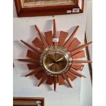 A mid 20th century brass and teak sunburst wall clock by Anstey & Wilson, diameter 53.5cm.