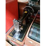 A hand cranked cased Singer sewing machine, (no key to the case)