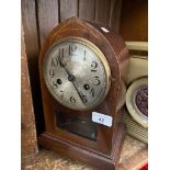 An early 20th century mahogany cased clock, with pendulum and key.