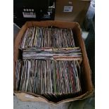 A box of 7" vinyl singles records