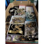 A tray of costume jewellery including silver.
