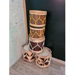 A set of 5 wooden drums with straps.