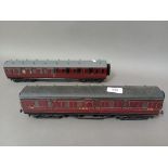 Two 0 gauge maroon coaches.