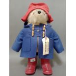 A Gabrielle Designs Paddington Bear with labels.