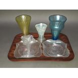 Six pieces of John Walsh iridescent glass comprising a pair of dishes, three vases and four vases,