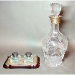 An etched cut glass decanter with silver top together with a set of desk inkwells with silver tops