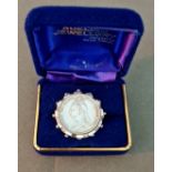 A hallmarked silver brooch with a revolving 1890 silver shilling bearing Queen Victoria - jubilee,