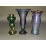 A group of three Art Nouveau iridescent glass vases comprising a twist and dimple vase attributed to
