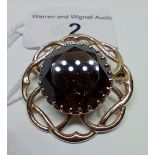A 9ct gold brooch with central smoky quartz stone, gross weight 9.8 grams.