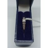 A white metal diamond ring, marked DIA 0.25 ct in associated box, size I/J, wt. 3.6g.