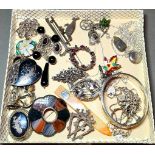 A collection of hallmarked silver and white metal jewellery to include brooches, Scottish, Siam,