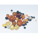 Assorted loose stones comprising opals, amber and garnet varieties, gross wt. 35 carats.