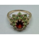 A hallmarked 14ct gold spessartite and demantoid garnet ring, size R, gross wt. 4.2g.