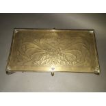 An Arts & Crafts Keswick School of Industrial Arts brass trivet, decoration depicting two mythical